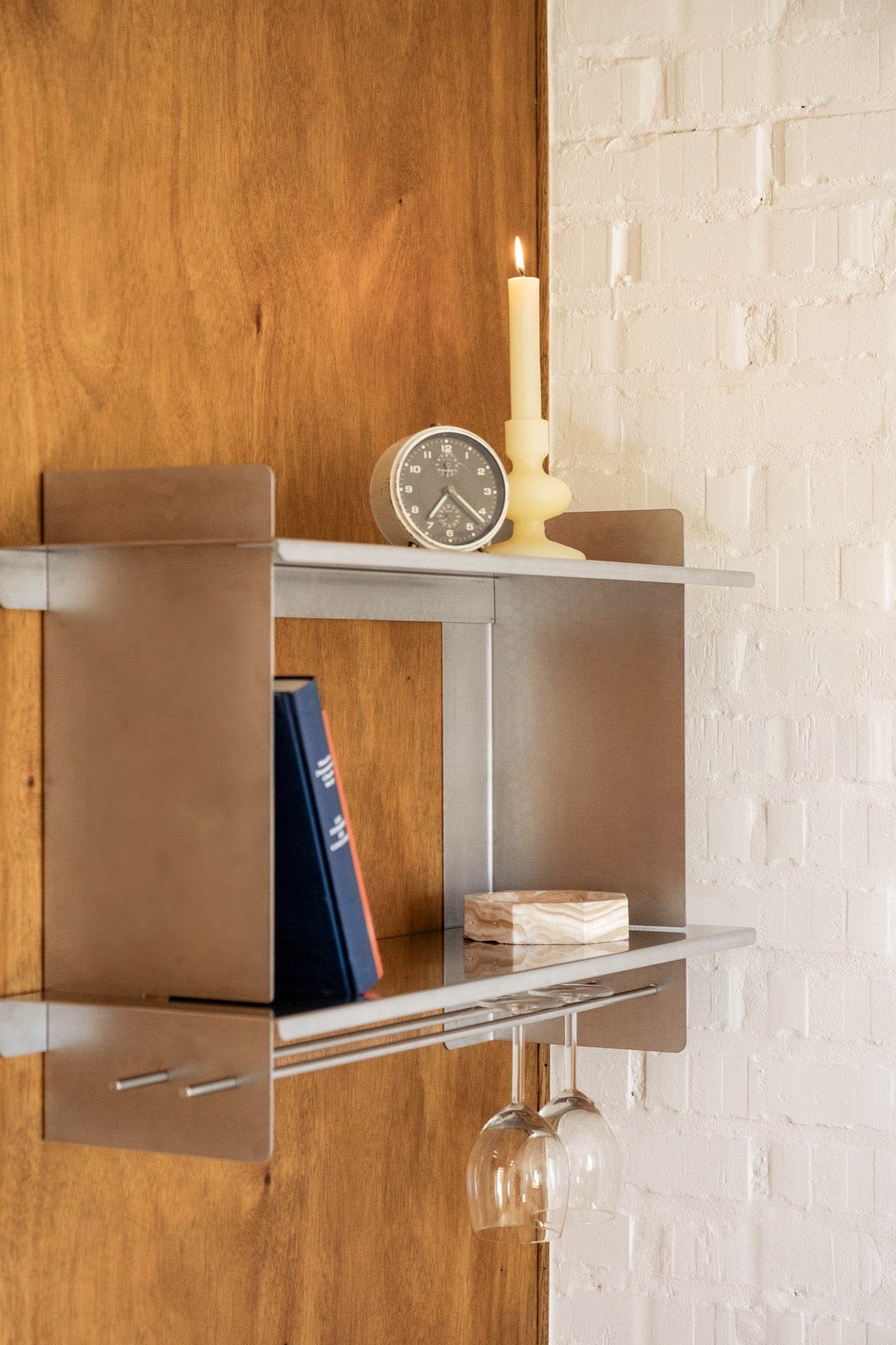 the Tivo Shelf Short in stainless steel mounted on a kitchen wall storing kitchen supplies